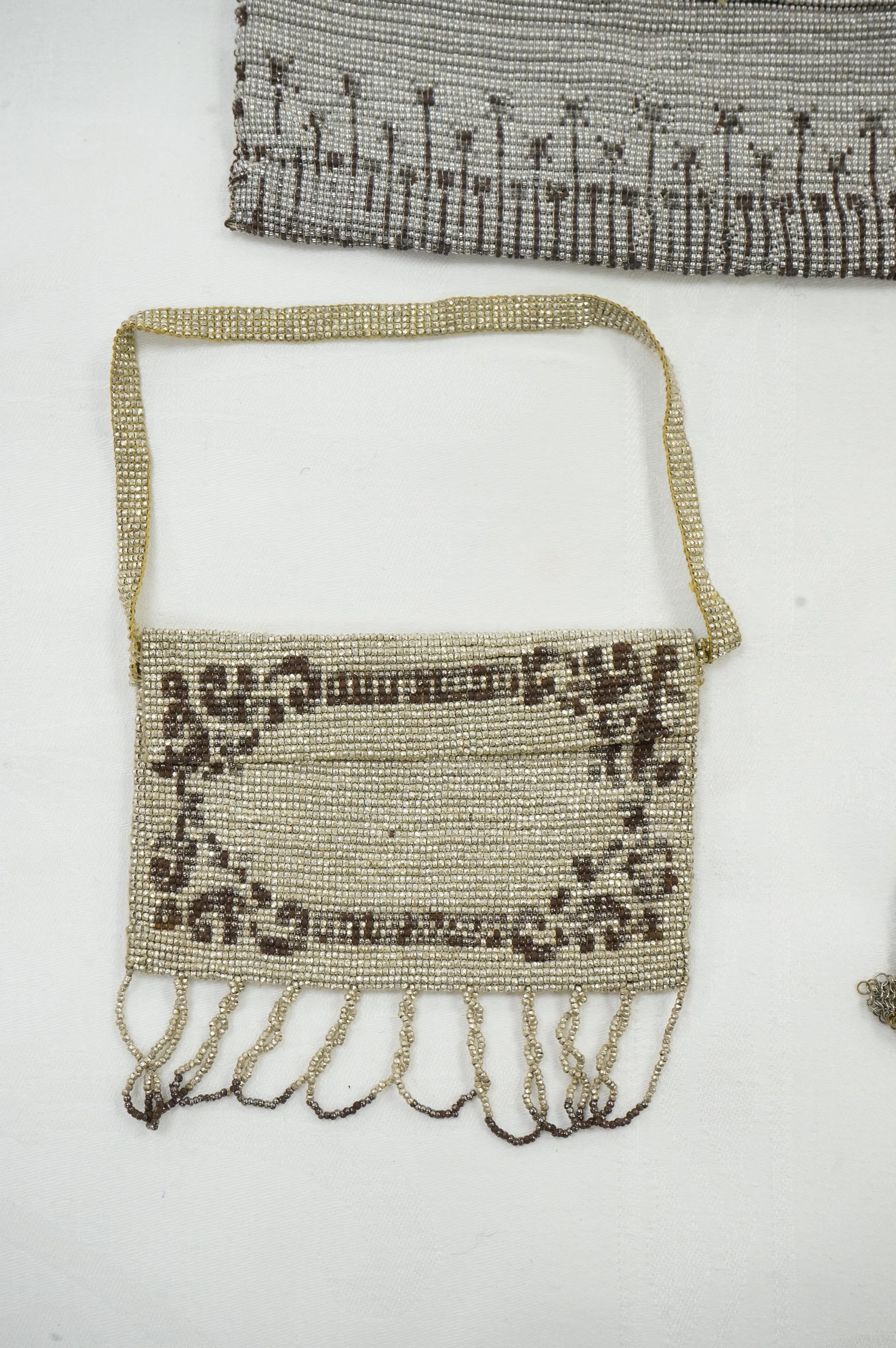 An Art Deco coloured metal chain mail evening bag together with a silver metal bead, blue clasped evening bag and smaller purse., Chain mail bag 13.5cm high. Condition - good on all three.